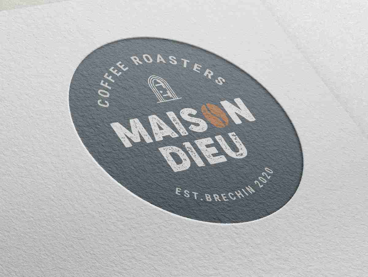 Logo of Maison Dieu Coffee Roasters featuring a coffee bean and text in a circular design.