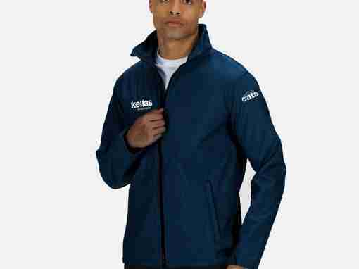 Navy Blue Jacket with Logos Man wearing a navy blue jacket with Kellas and Cats logos on the sleeves.