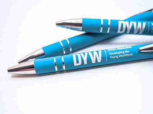 Blue Pens with DYW Branding Three blue pens featuring DYW branding and silver accents on a white background.