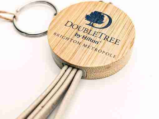 DoubleTree by Hilton Keychain Keychain featuring a round wooden tag with the DoubleTree by Hilton logo and tassels.